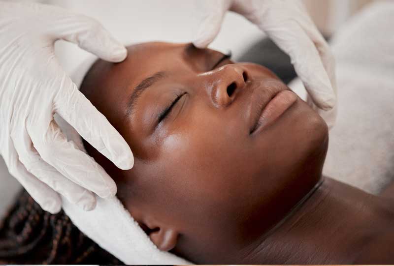 A beautiful woman getting a custom facial from Coastal Aesthetics.