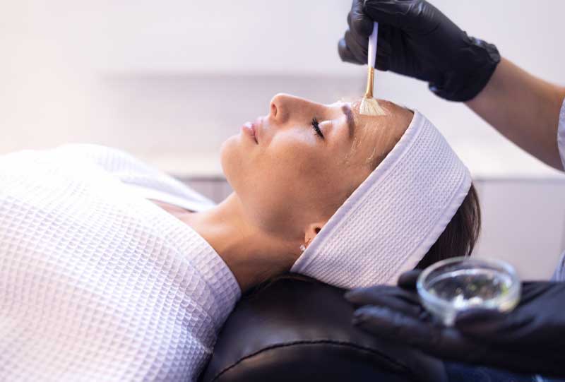 woman getting a chemical peel on her face.